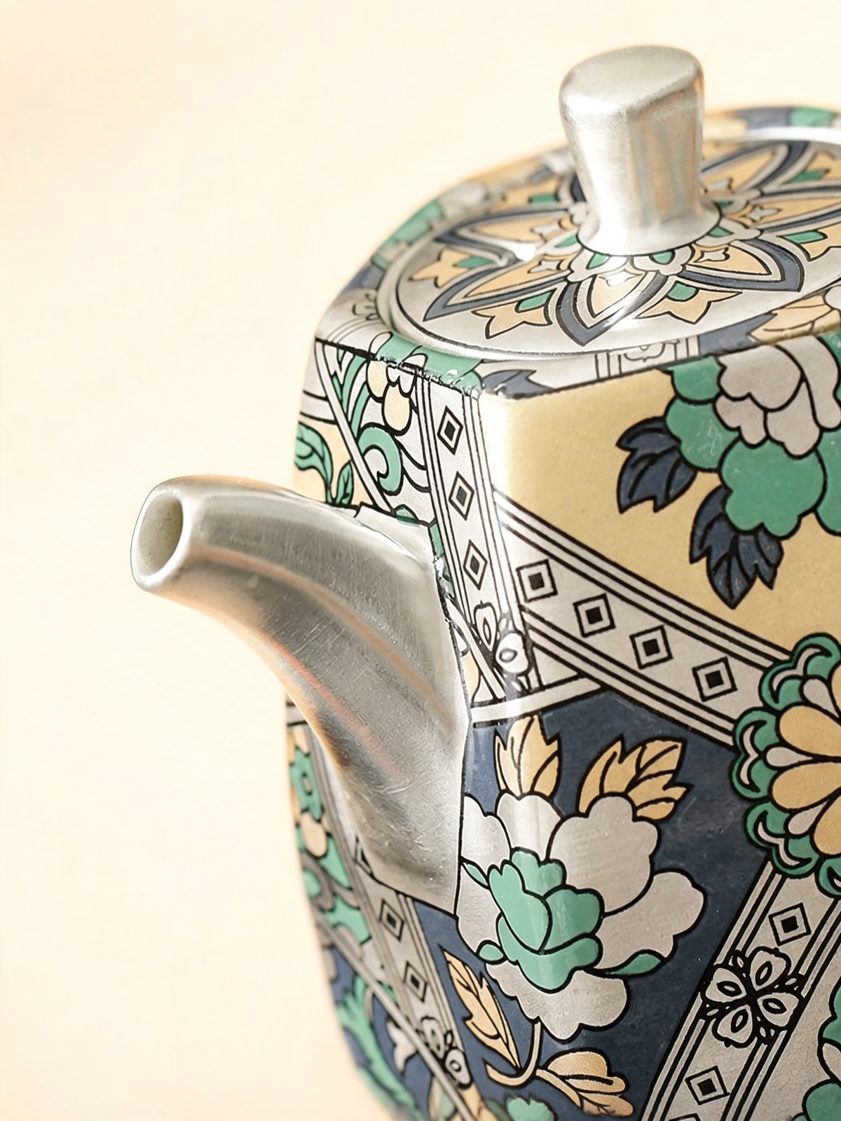 Detail of the turquoise and mint floral pattern on the Baihua teapot