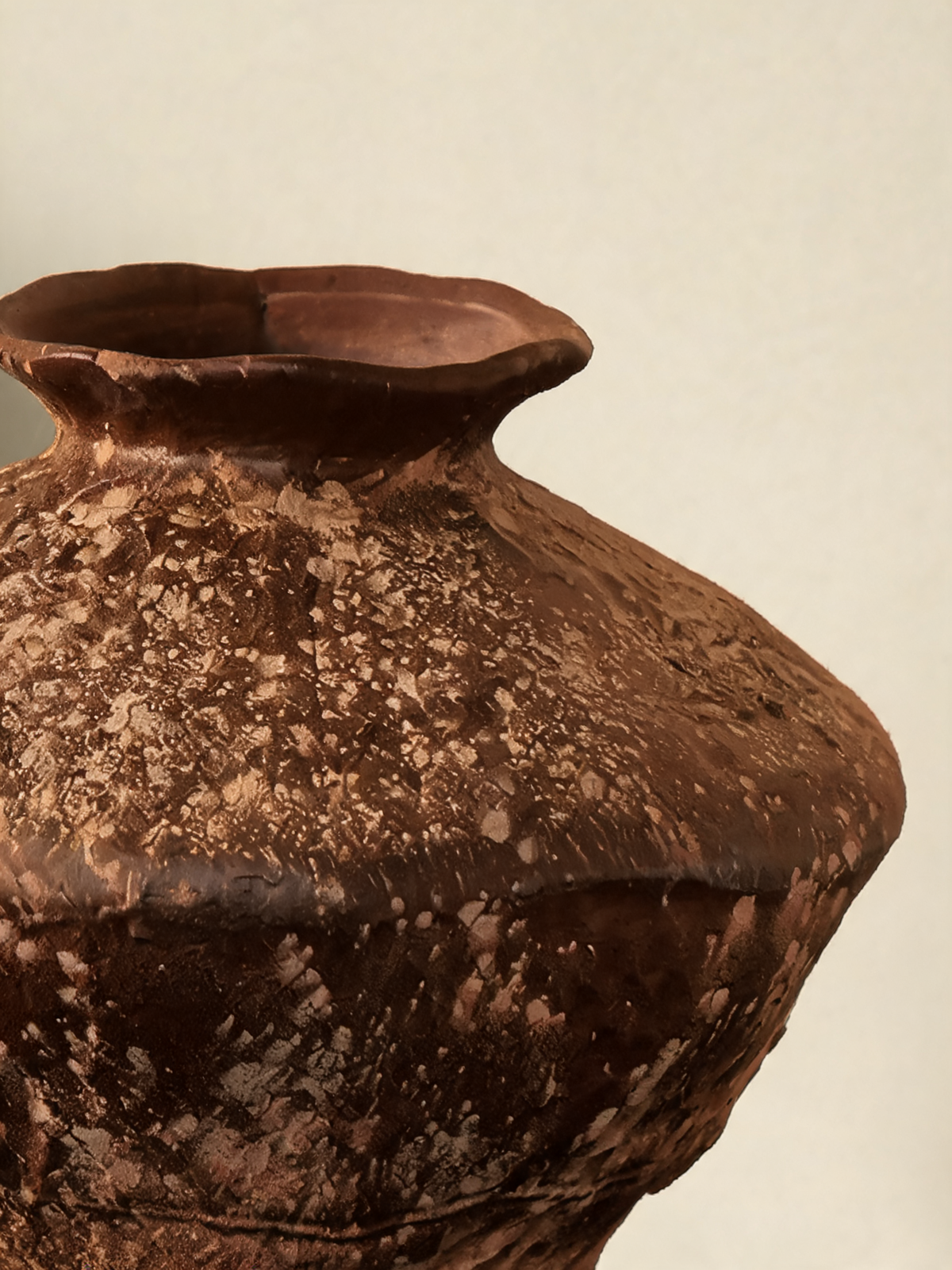Detail of the irregular mineral white patina on the raw ceramic