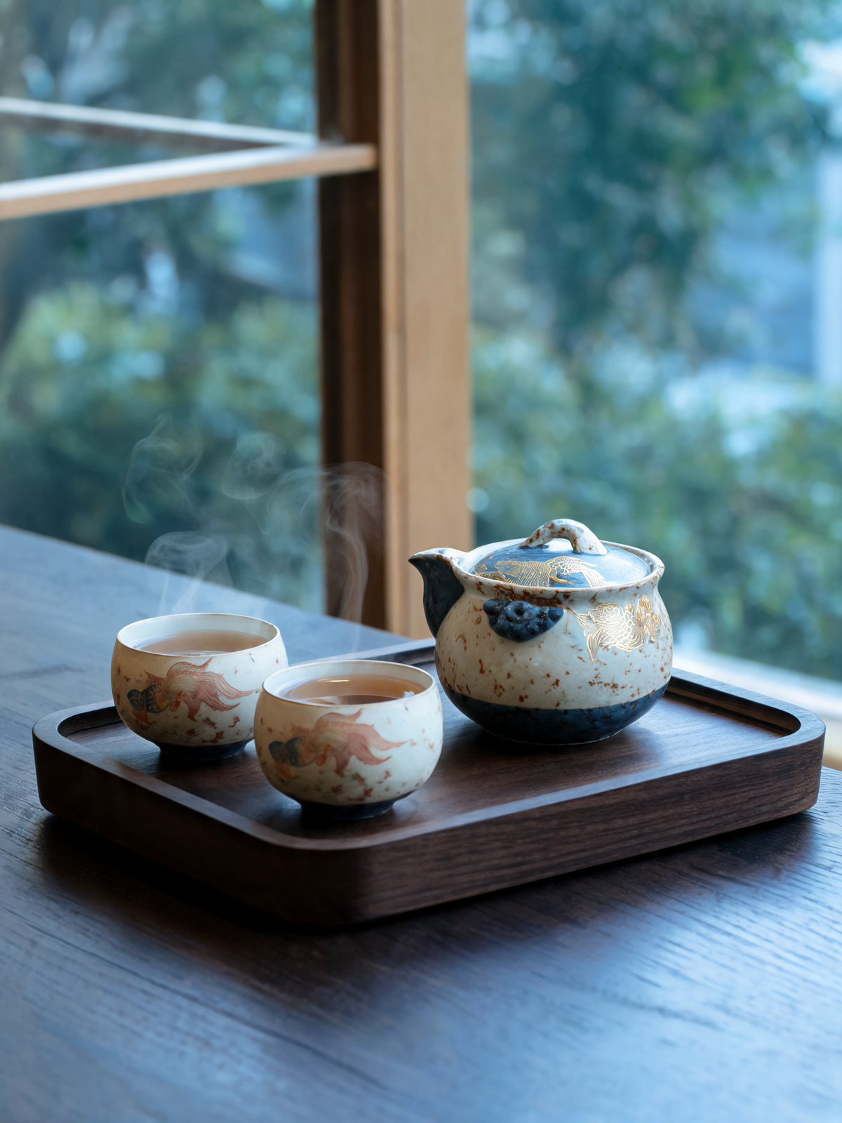 Detail of the gold koi motif on the Jinyu Mantang teapot