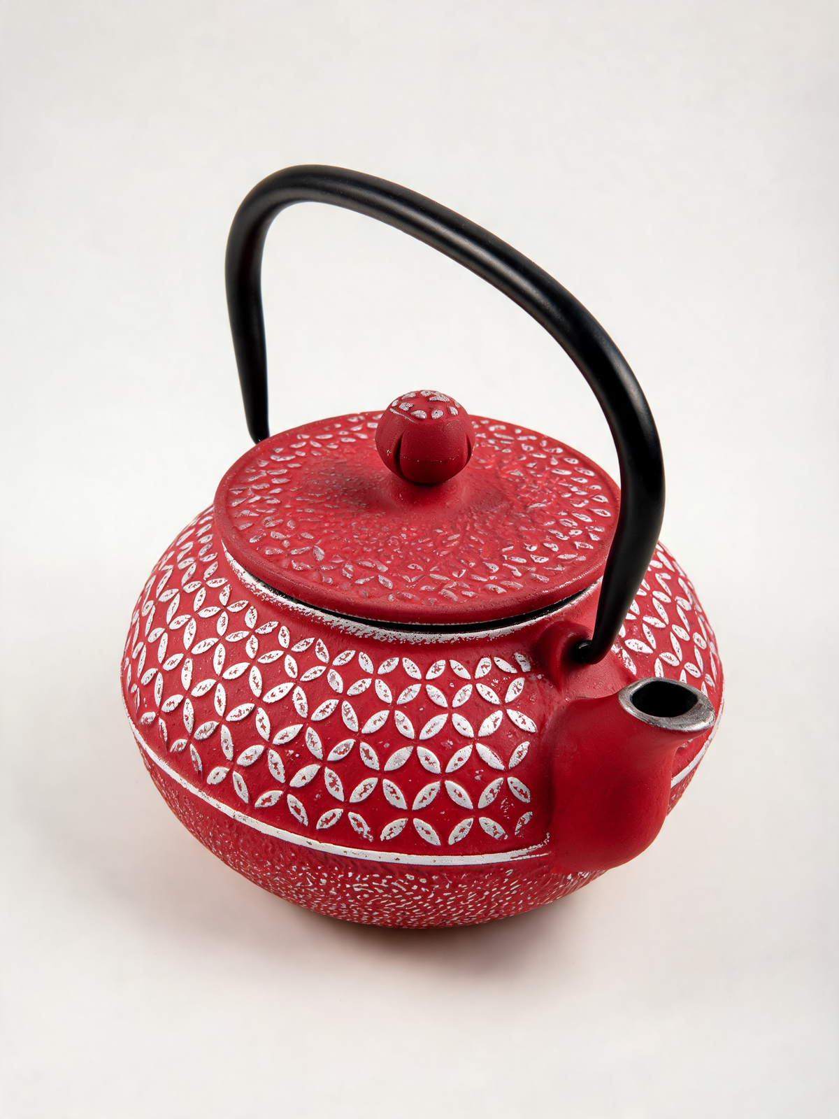 Detail of the raised floral pattern and silver accents on the Tetsubin Vermillon